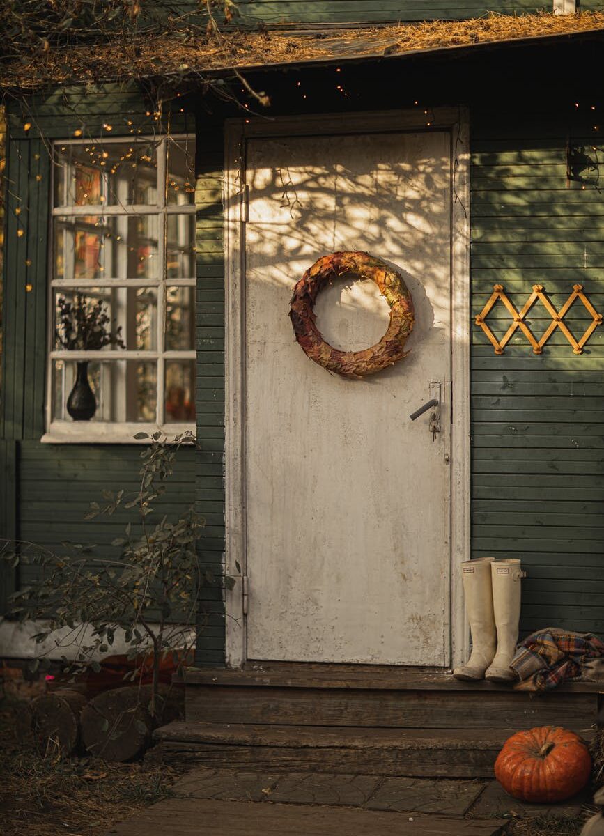 white wooden door with a wreath